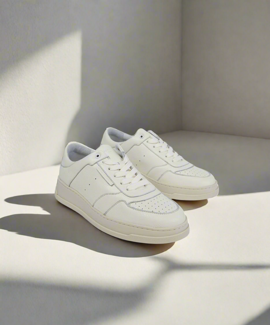 Pair of white Royal RepubliQ sneakers on a light gray background