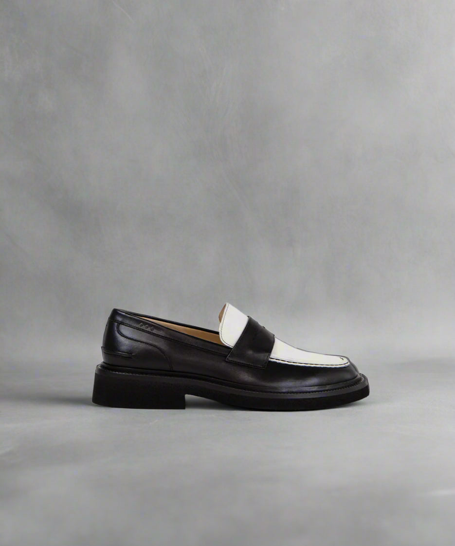 Royal RepubliQ Black and white loafer shoe on a gray background