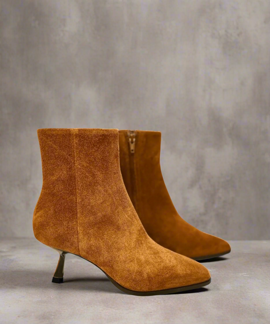 Pair of tan Royal RepubliQ suede ankle boots with a kitten heel on a gray background