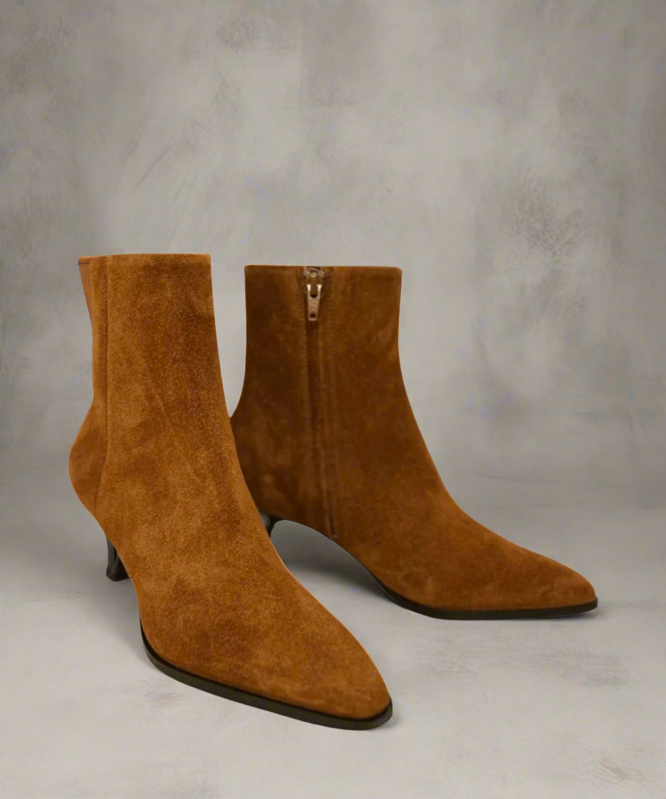 Pair of Tan Royal RepubliQ suede ankle boots with a kitten heel on a neutral background