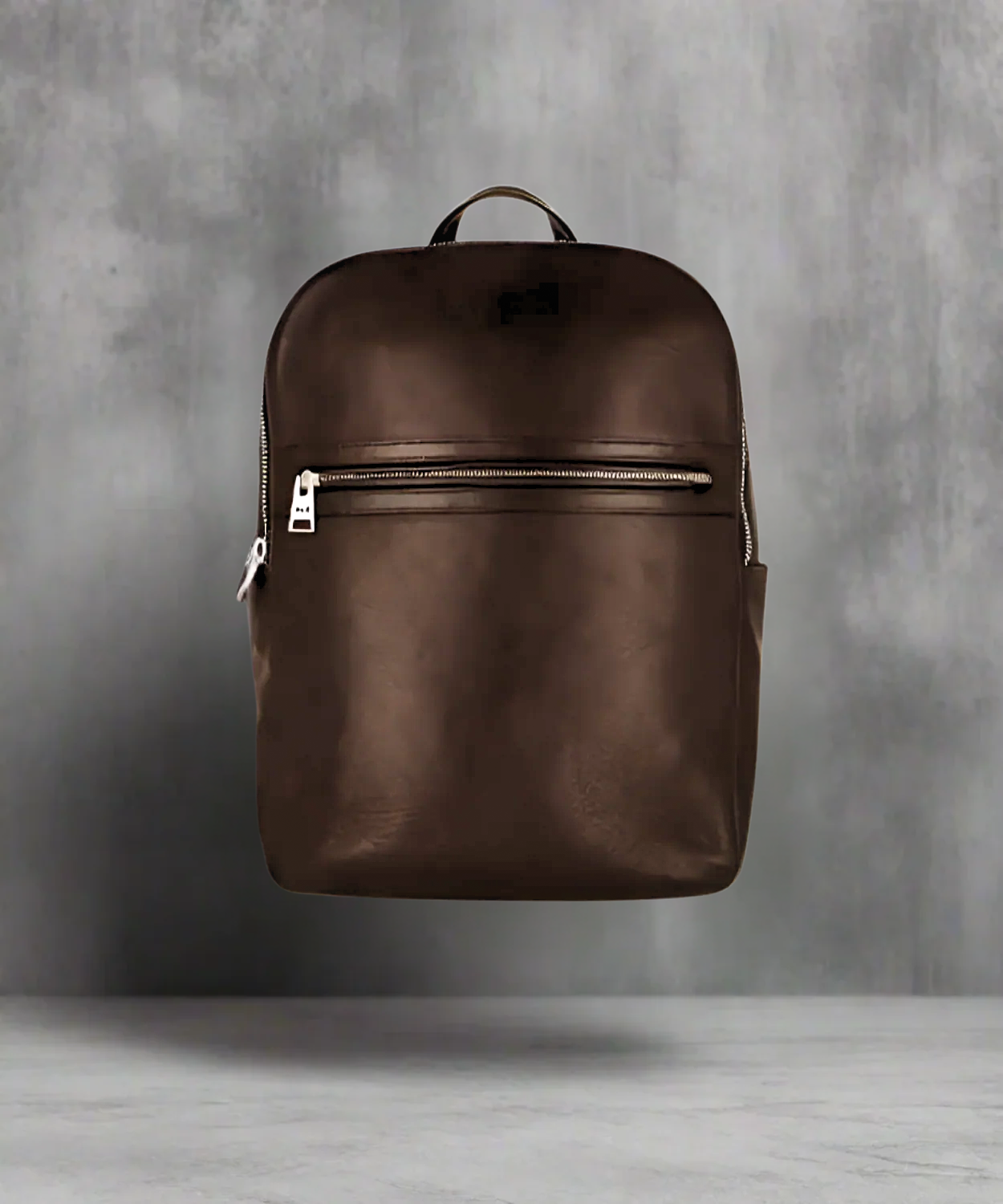 Brown Royal RepubliQ leather backpack on a gray background
