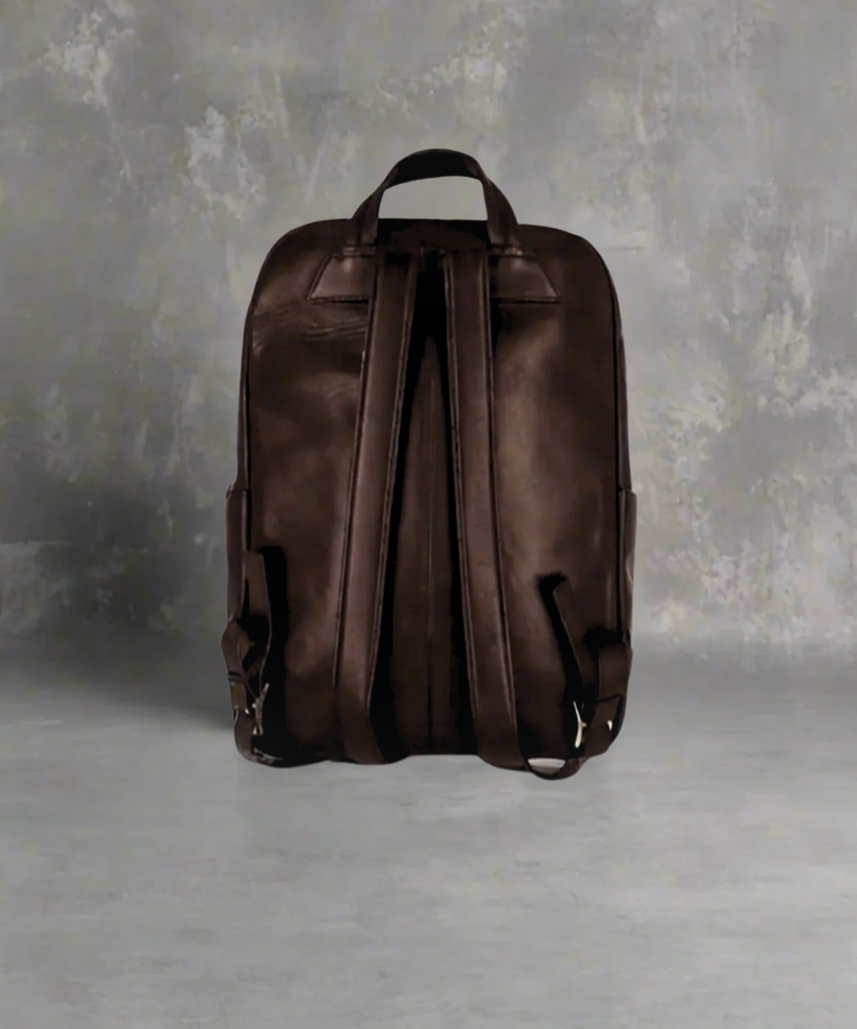 Brown Royal RepubliQ leather backpack on a gray background