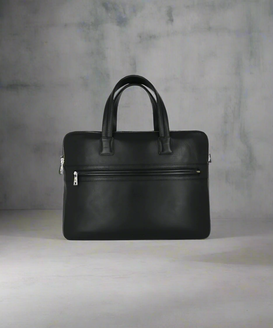 Black Royal RepubliQ leather briefcase on a gray background