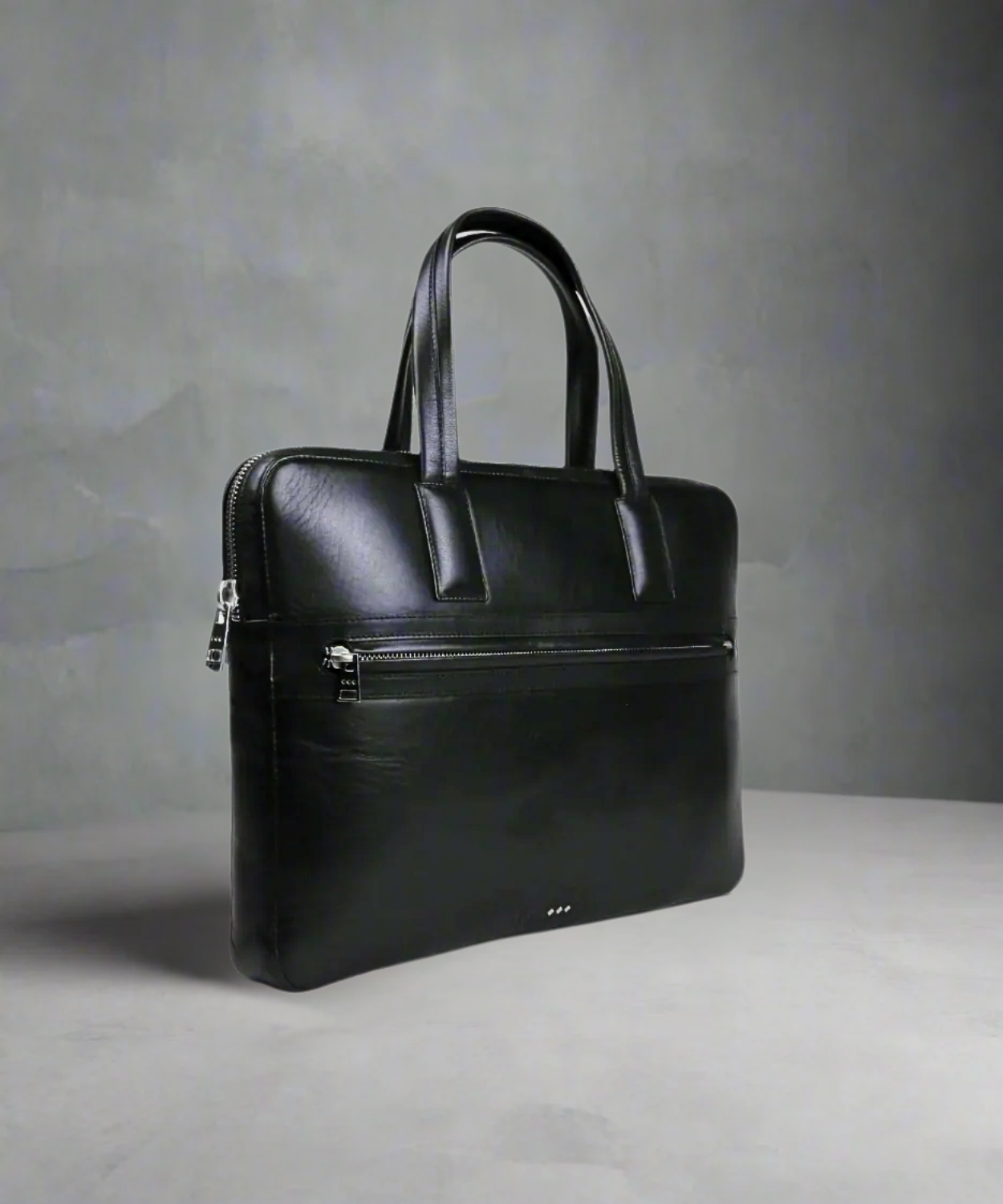 Black Royal RepubliQ leather briefcase on a gray background