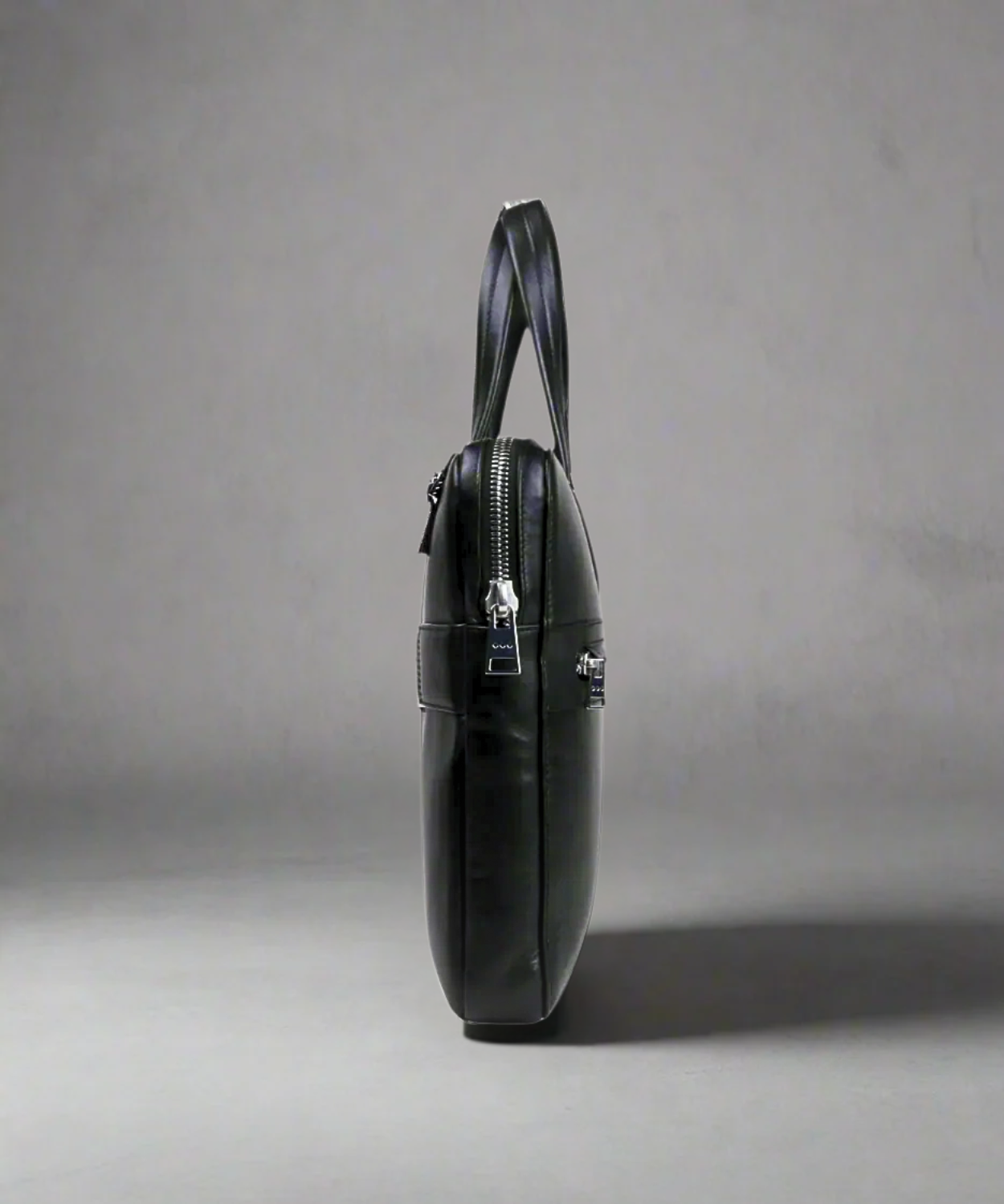 Black Royal RepubliQ leather briefcase on a gray background