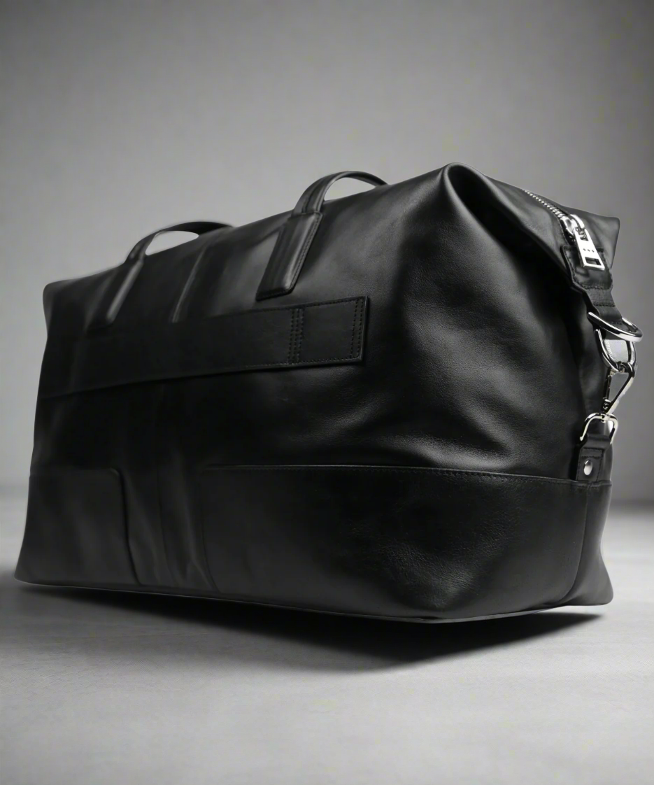 Black Royal RepubliQ leather bag with a strap on a white background