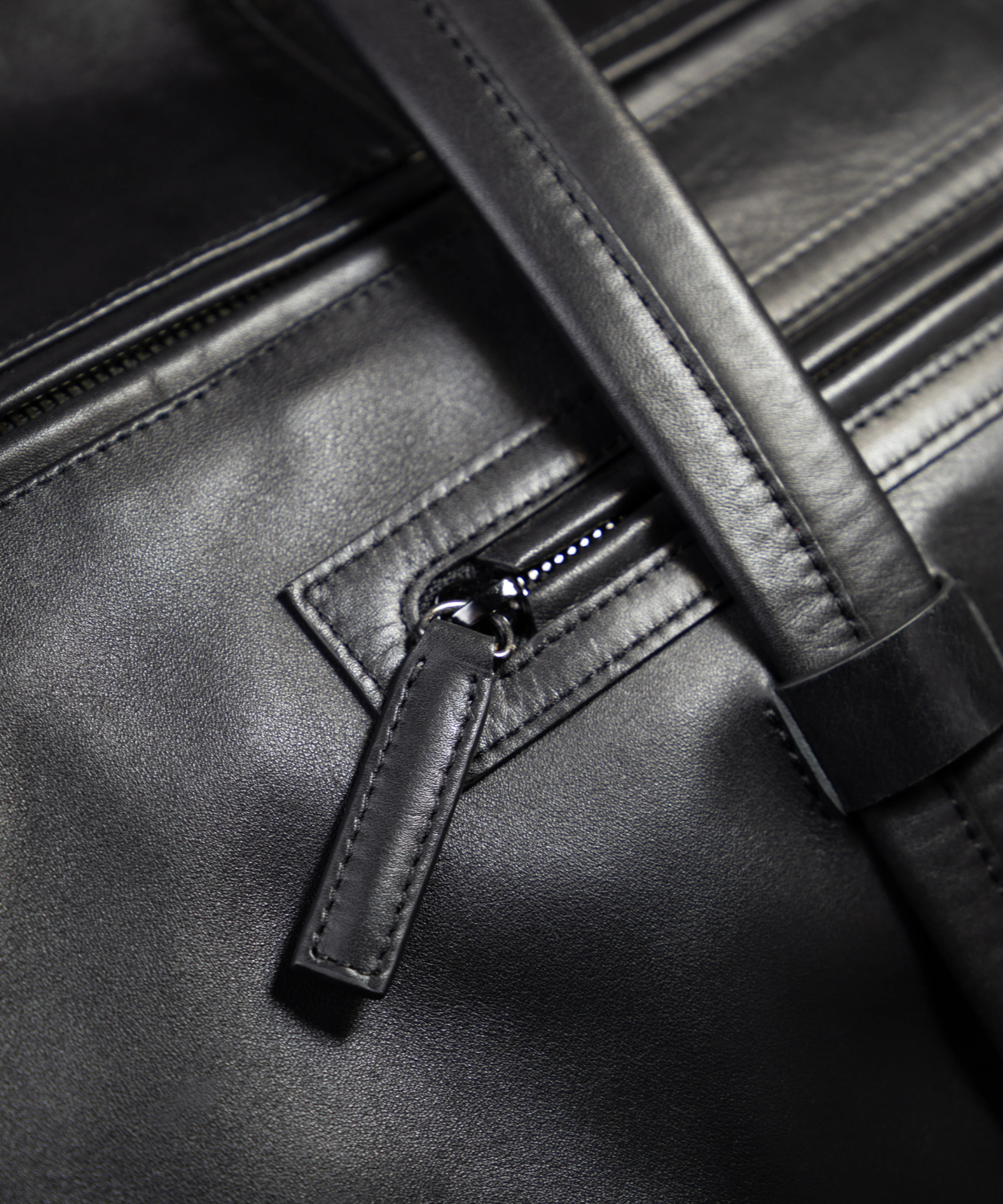 Close-up of a black Royal RepubliQ leather bag with a zipper