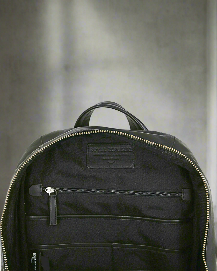 Black Royal RepubliQ backpack with visible brand logo on a gray background