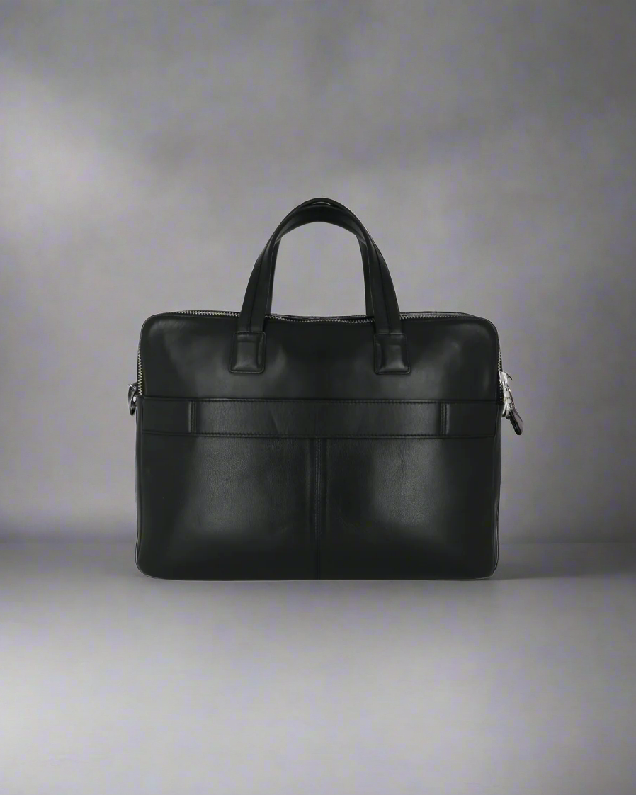 Black Royal RepubliQ leather briefcase on a gray background