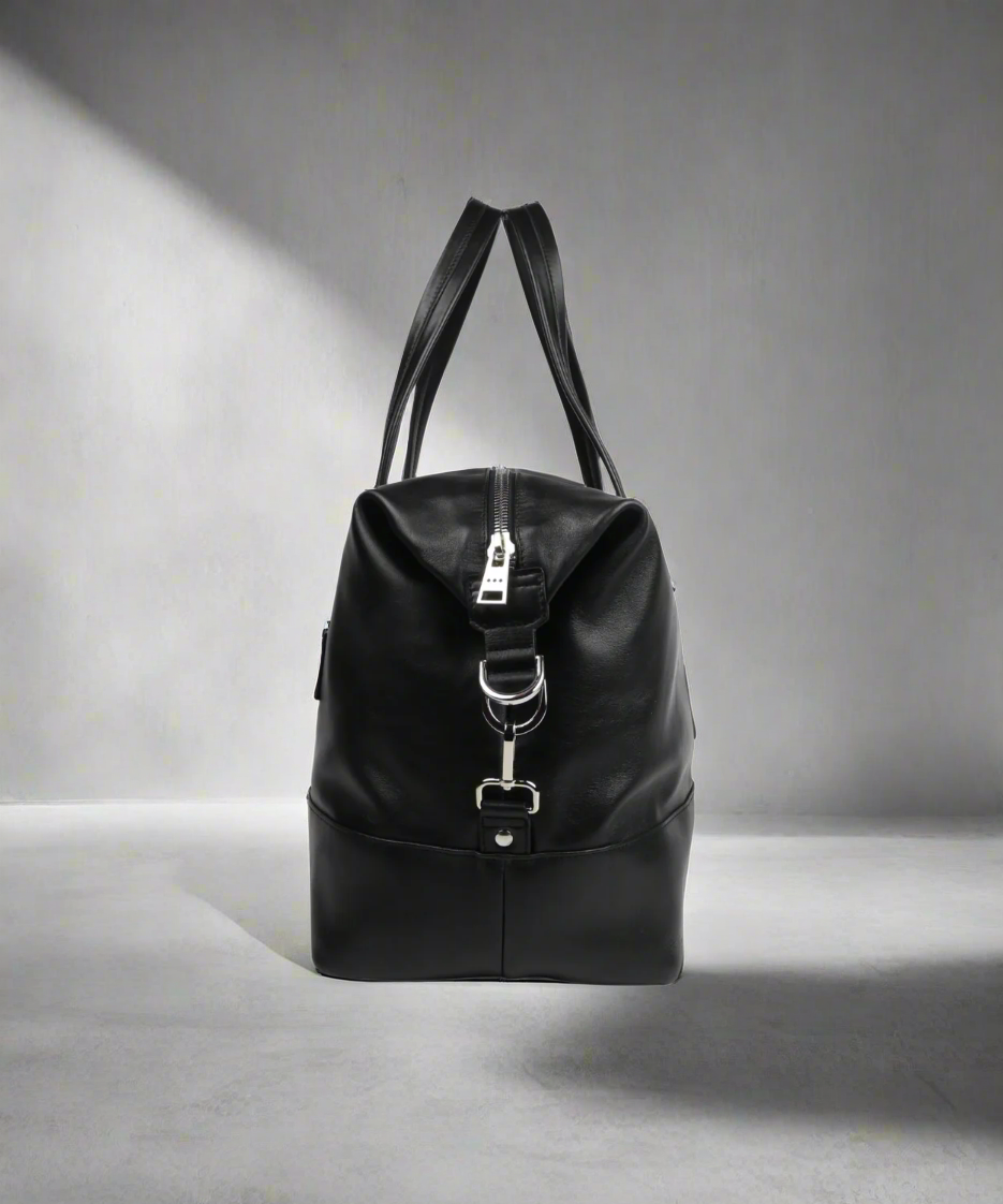 Black Royal RepubliQ stayover bag with silver zipper on a white background