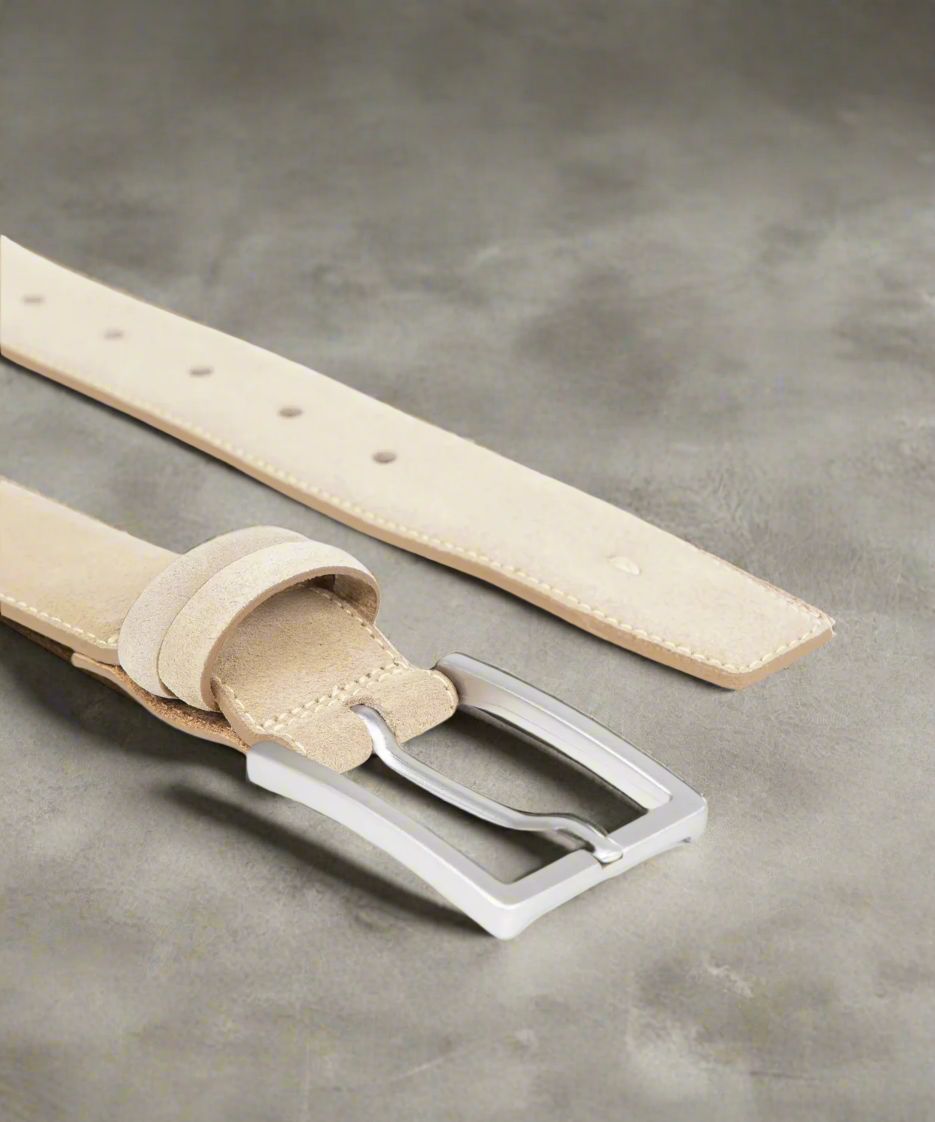 Beige Royal RepubliQ leather belt with a mstt silver buckle on a gray surface