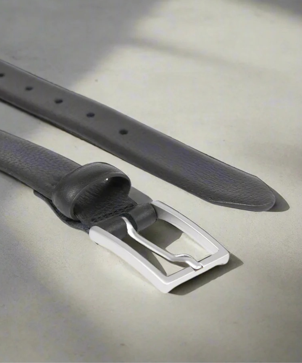 Black Royal RepubliQ Belt with a matt silver buckle on a light gray background