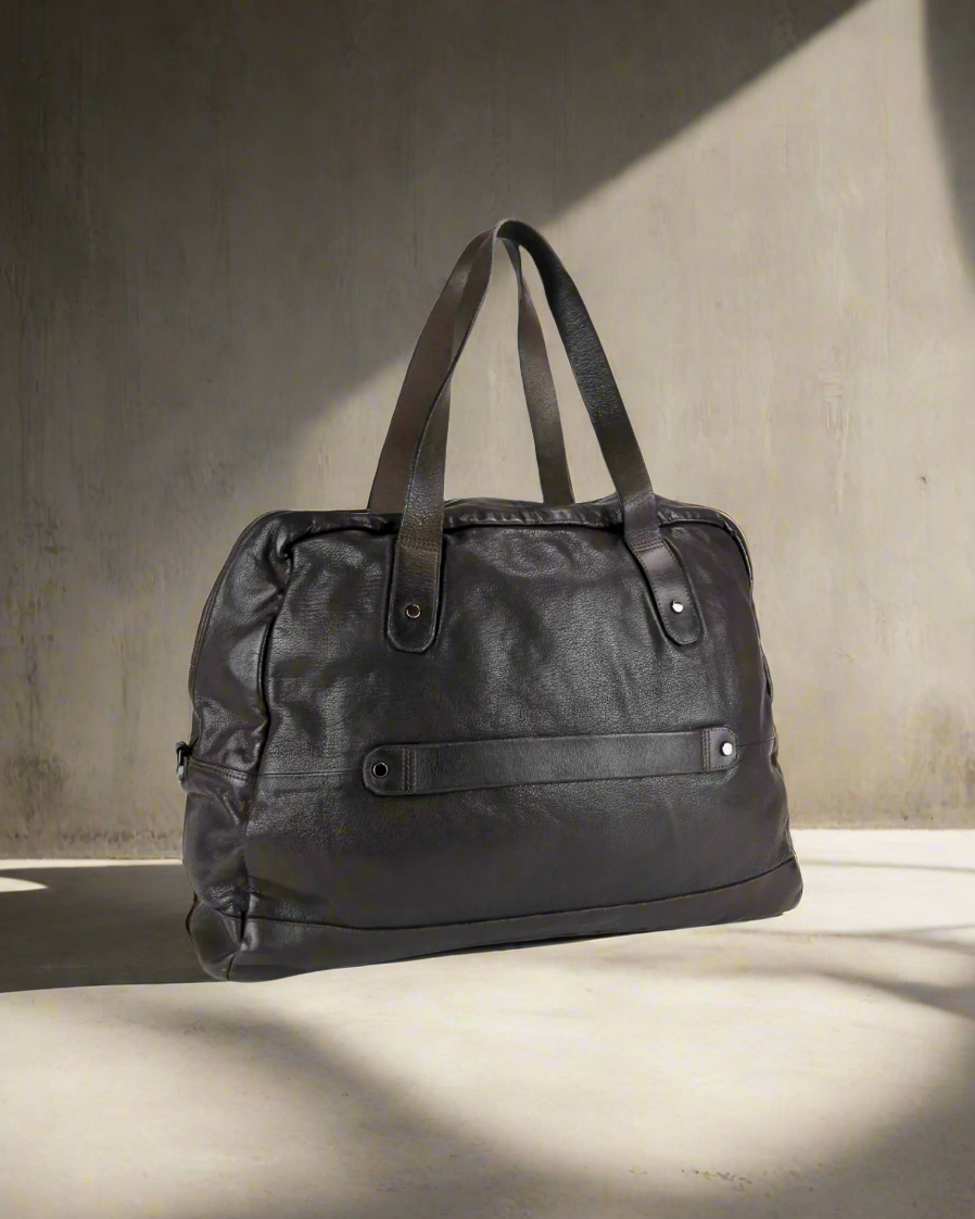 Dark Brown Royal RepubliQ washed leather duffel bag on a gray background