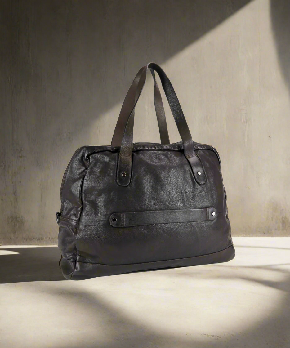 Dark Brown Royal RepubliQ washed leather duffel bag on a gray background