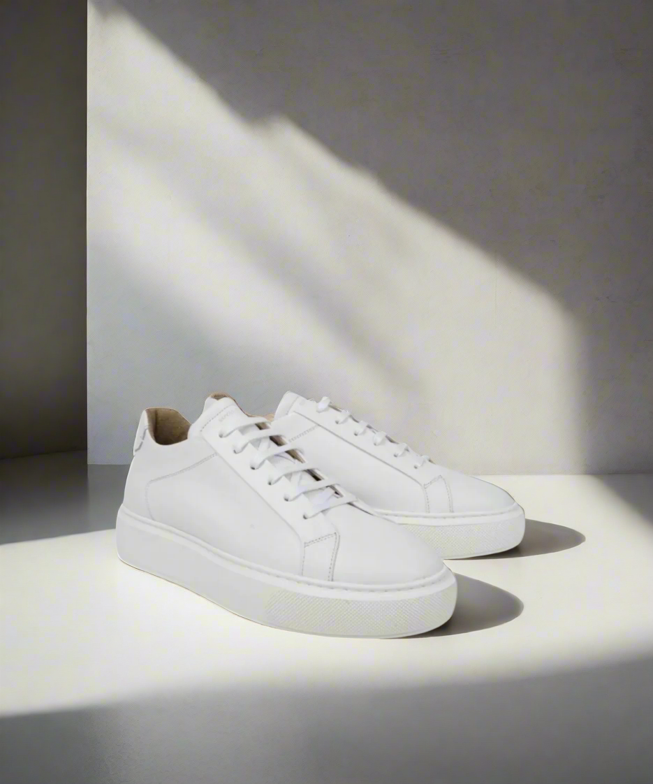 White Royal RepubliQ leather sneakers on a light surface with a soft shadow