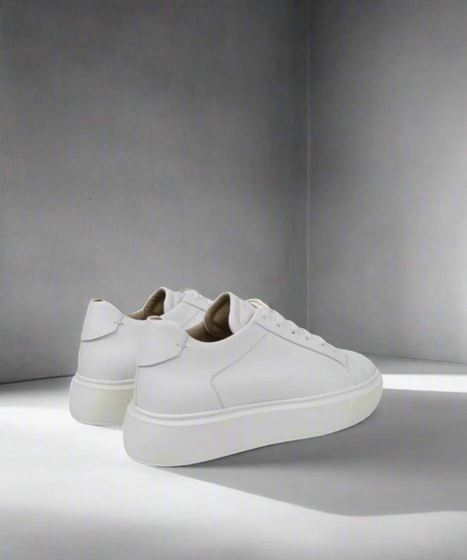 White Royal RepubliQ leather sneakers on a gray background