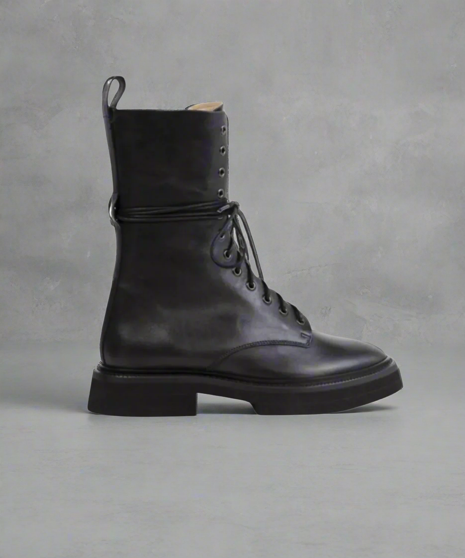 Black leather boot with laces on a white background
