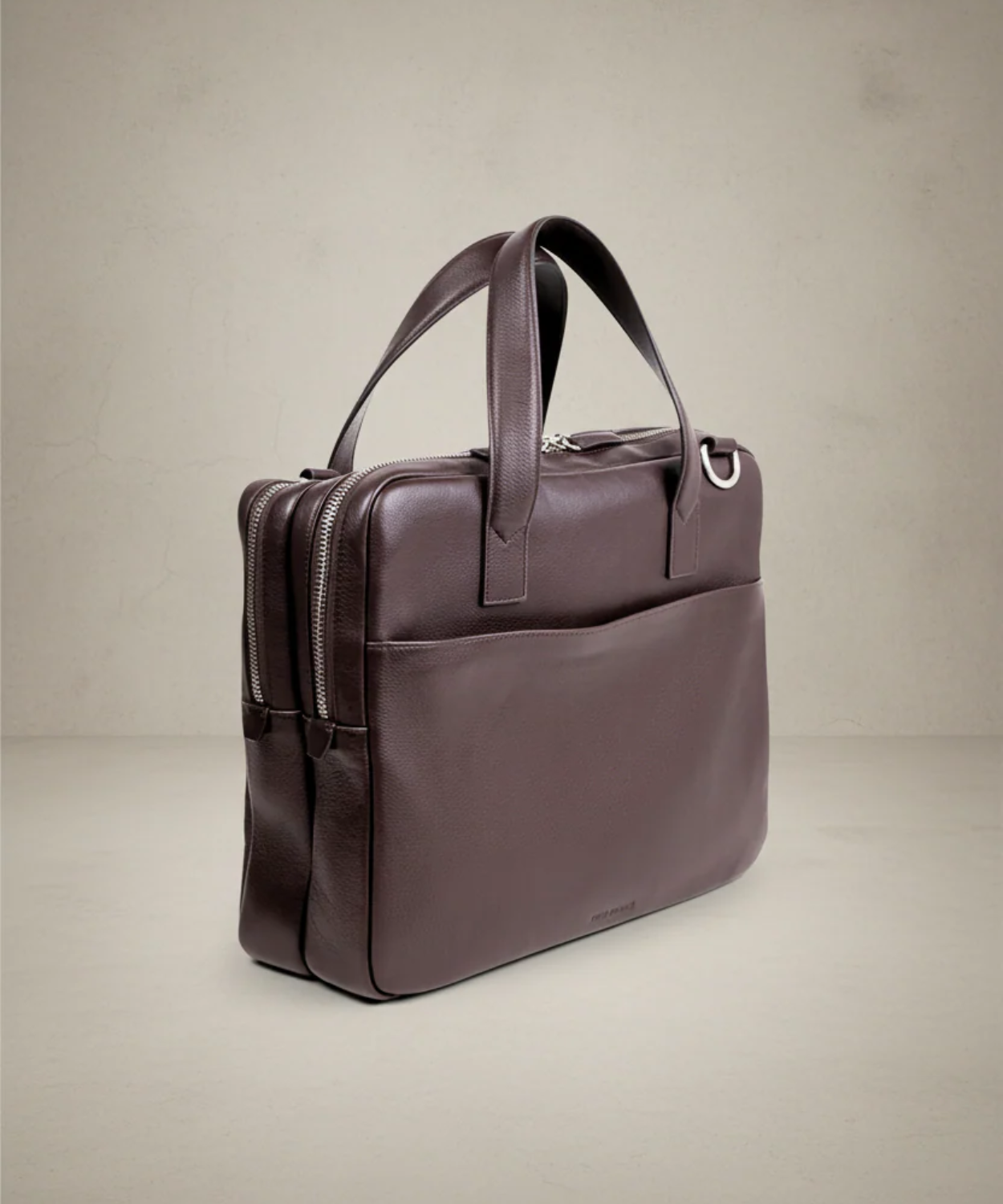 Brown leather briefcase on a beige background