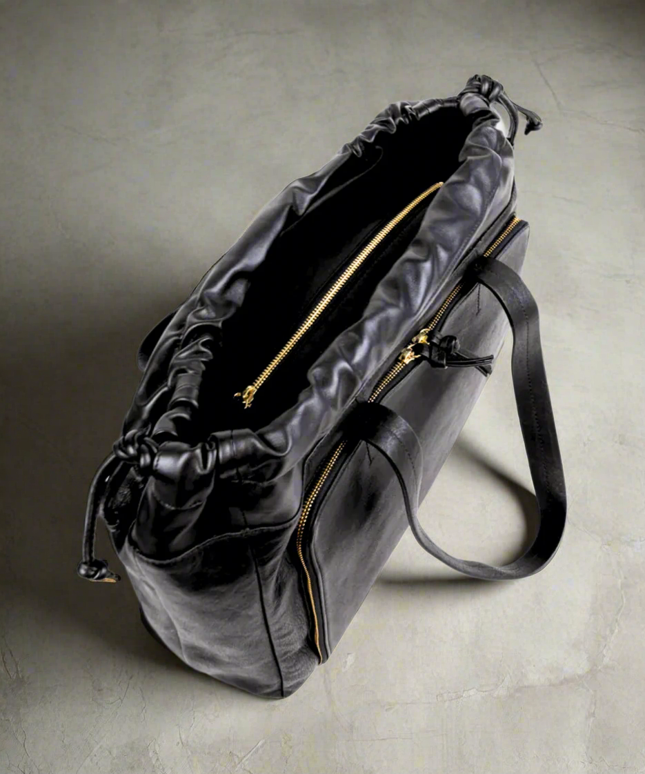 Black Royal RepubliQ leather duffel weekend bag for women on a gray background.