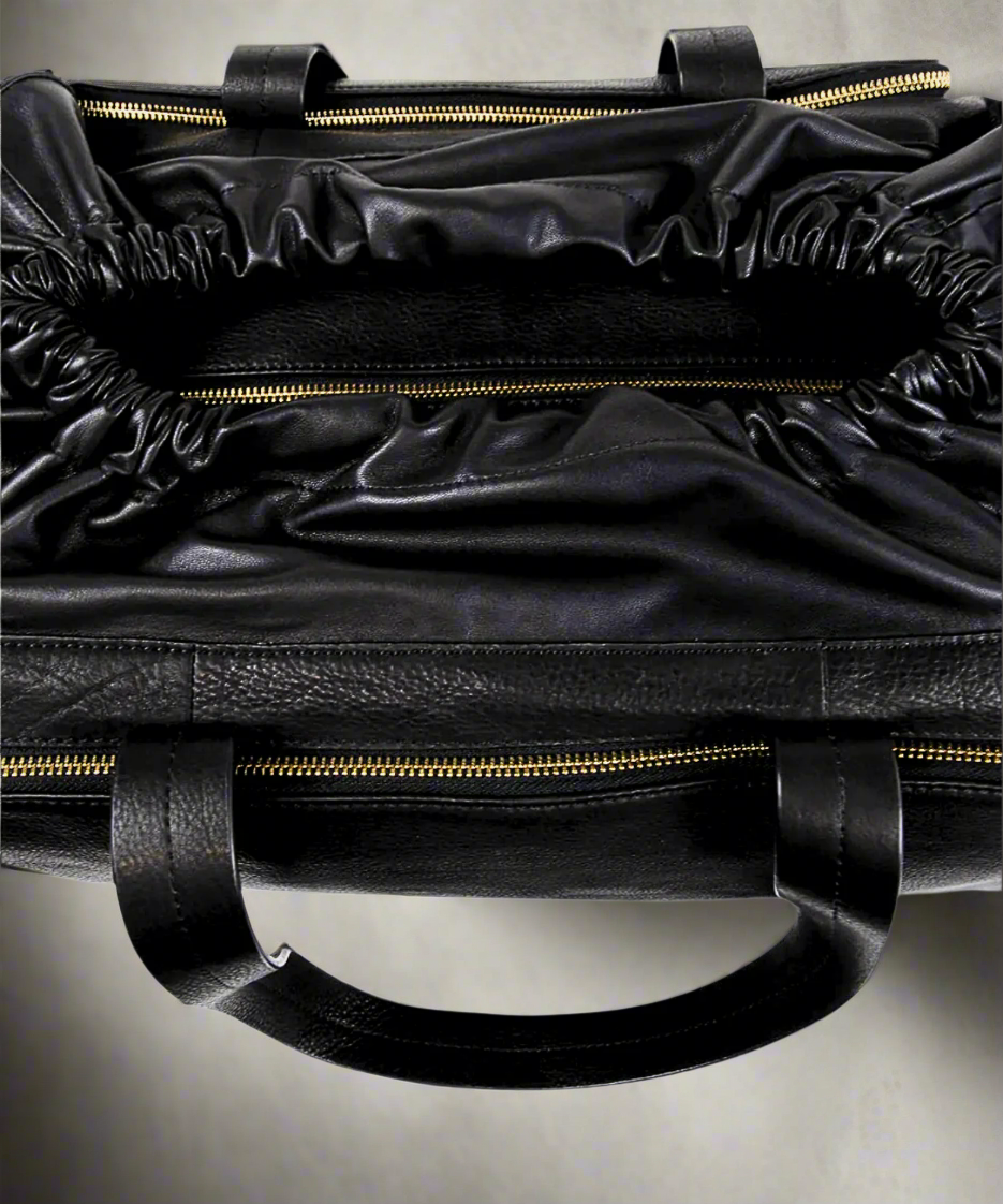 Top view of Black Royal RepubliQ leather duffel weekend bag for women on a gray background.