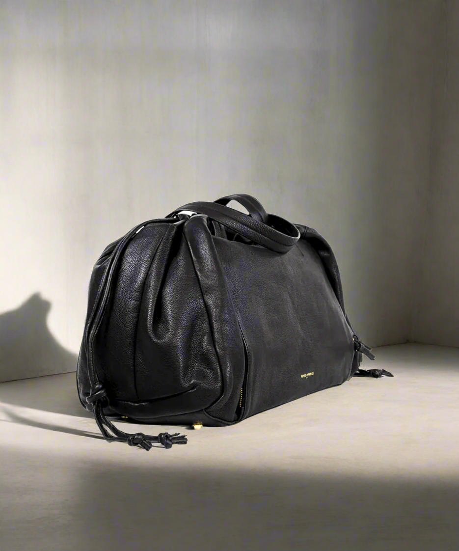 Black Royal RepubliQ leather duffel weekend bag for women on a gray background.