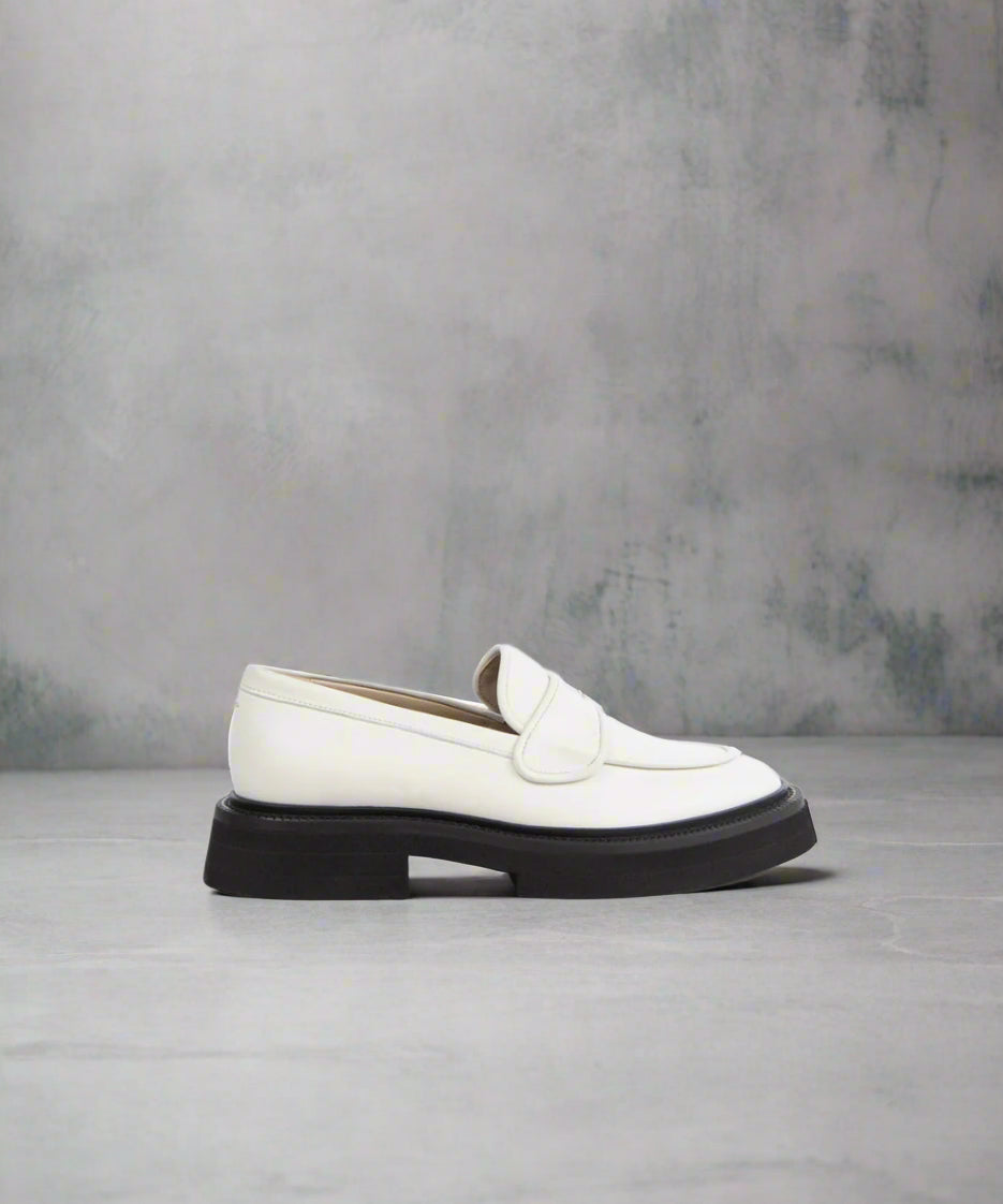 An off white Jinx Blox Loafer for women with a sleek and elegant design, featuring a closed toe and a flat sole.