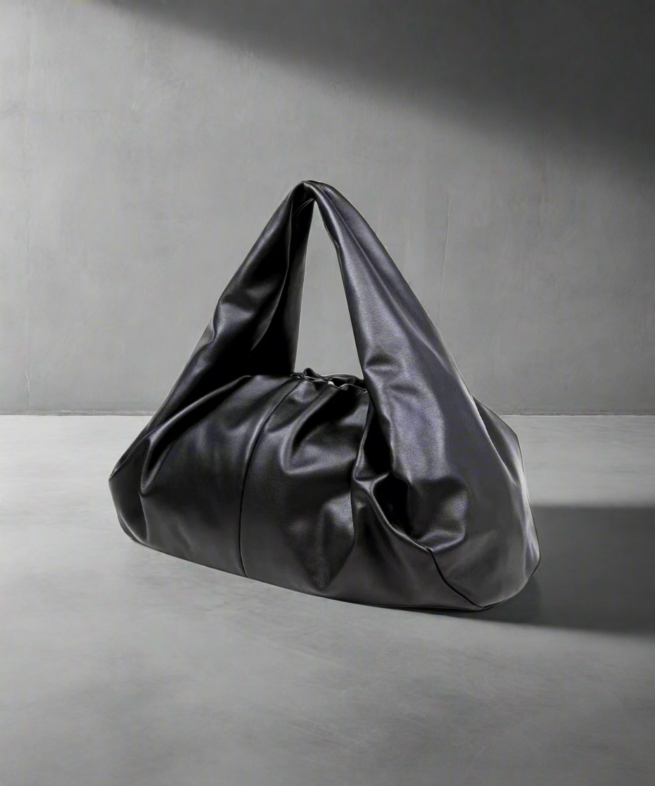 Black Royal RepubliQ leather oversized Pouch handbag on a gray background