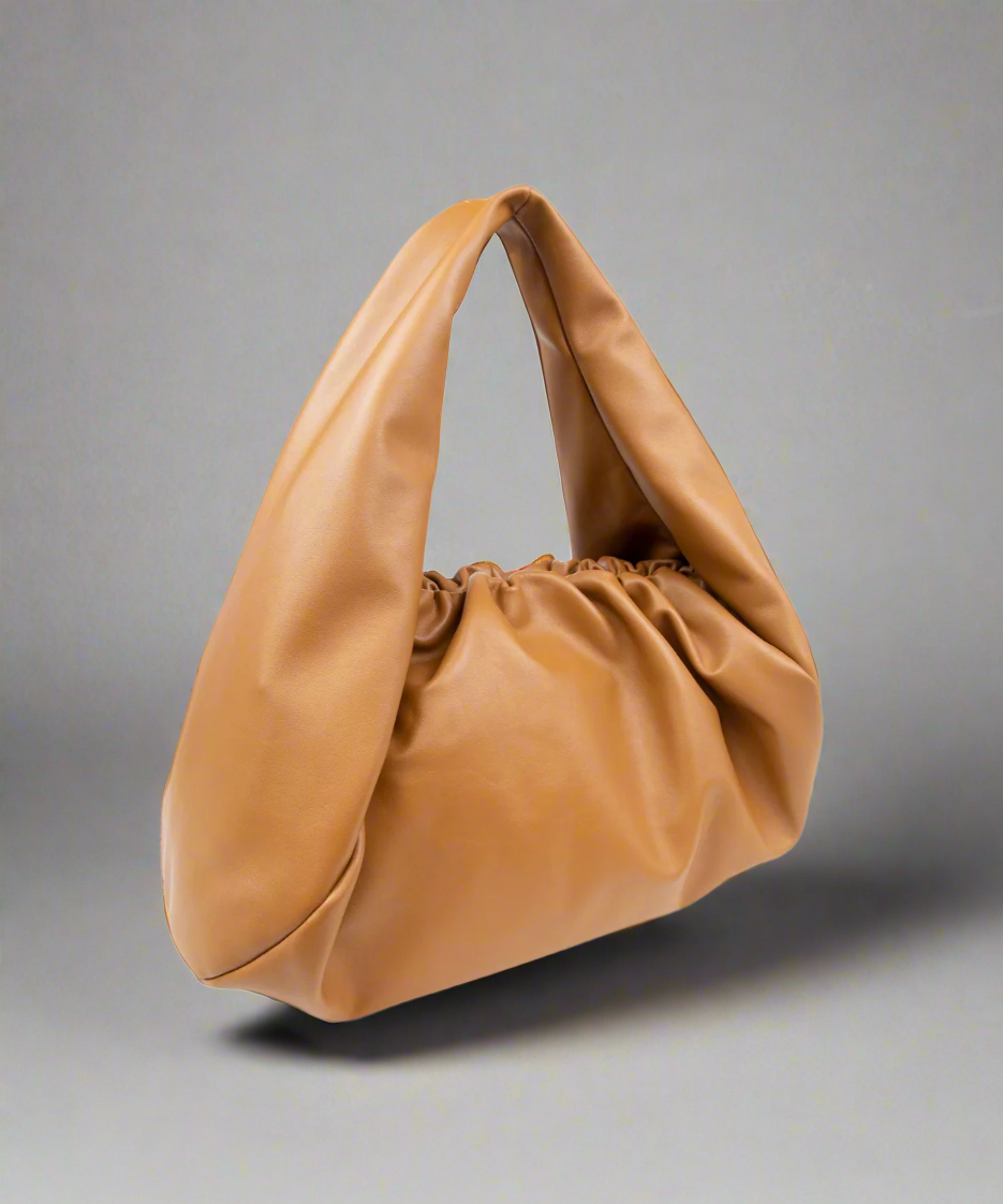 Tan handbag on a gray background