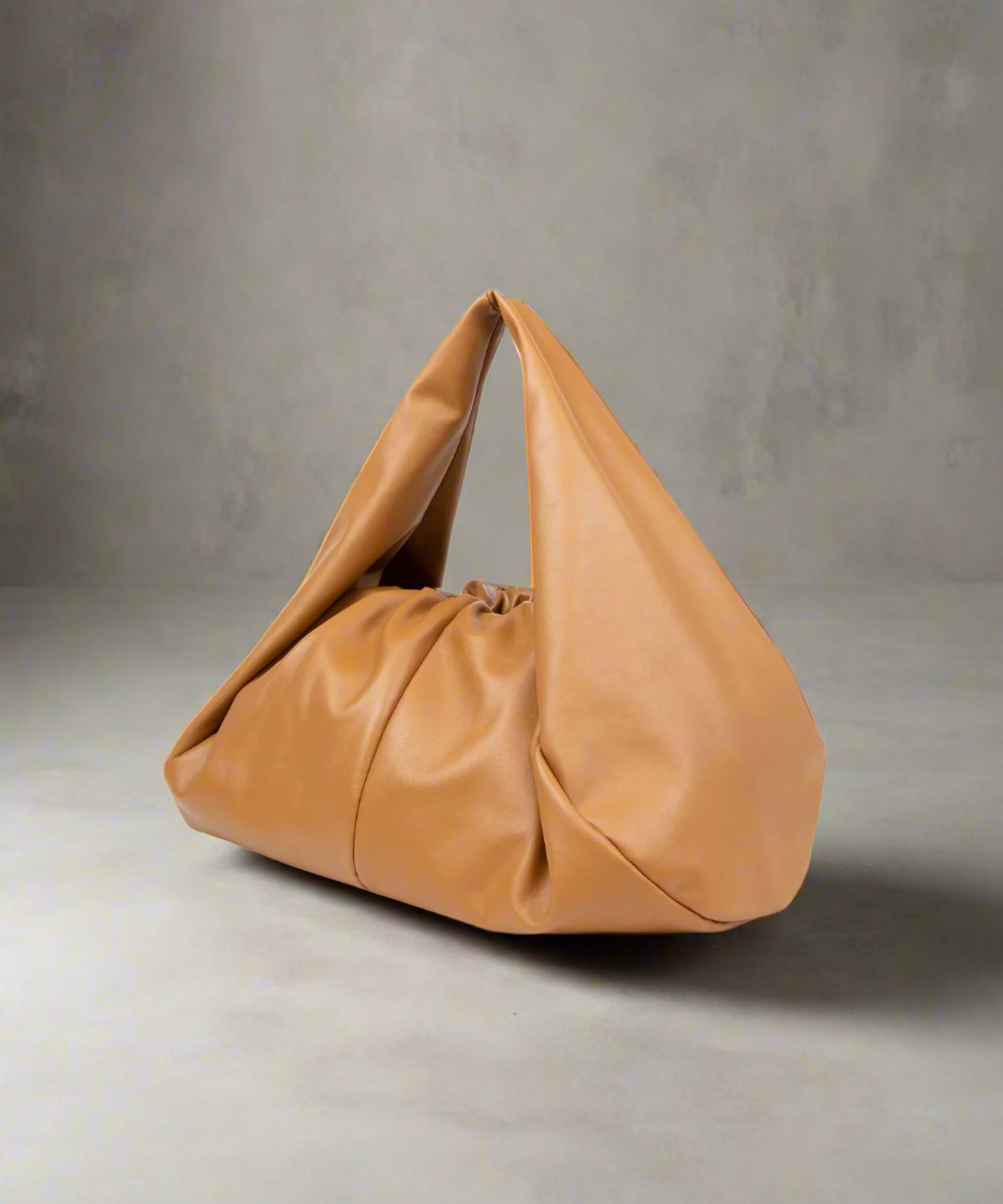 Tan handbag on a gray background