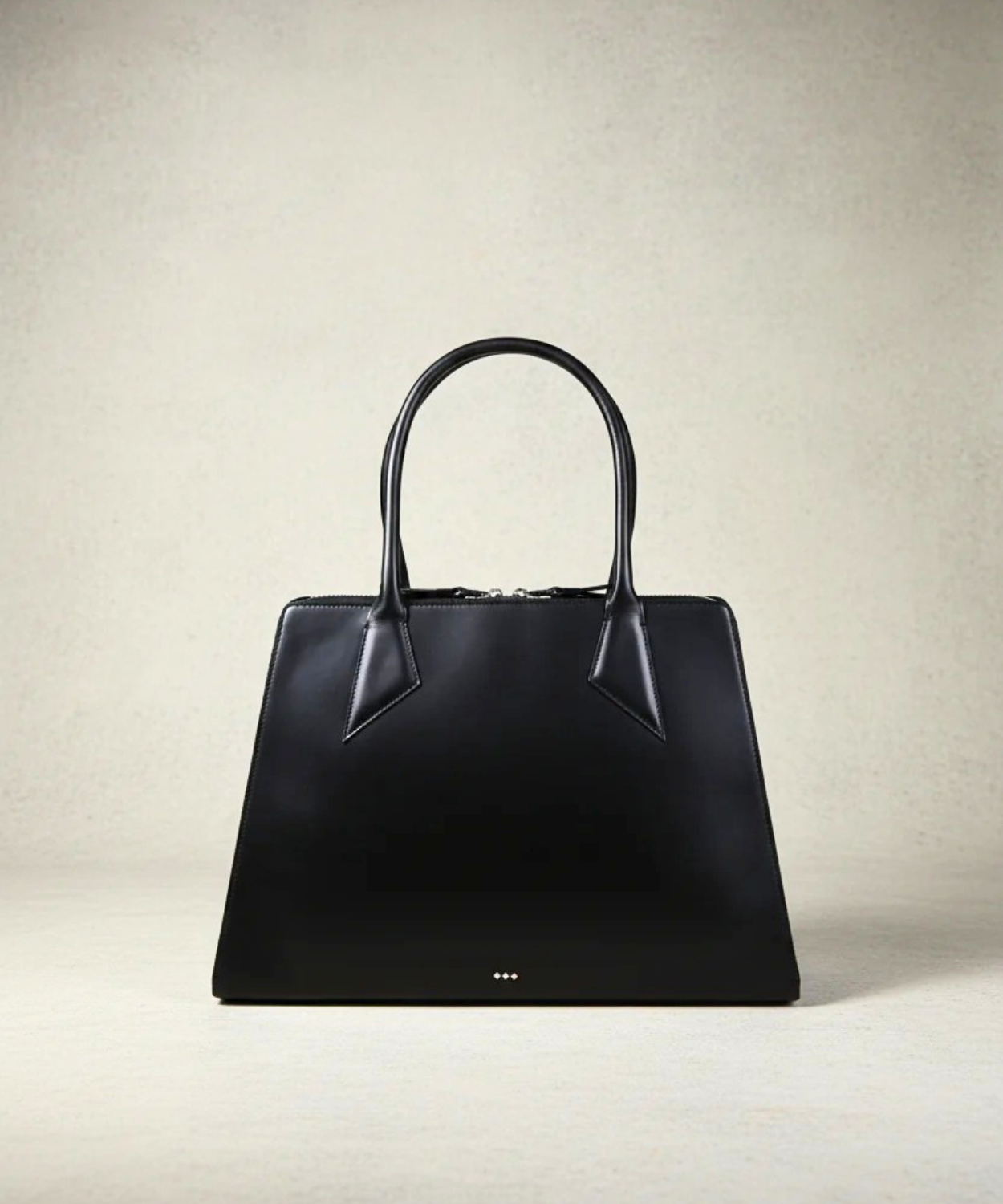 Black handbag on a light beige background