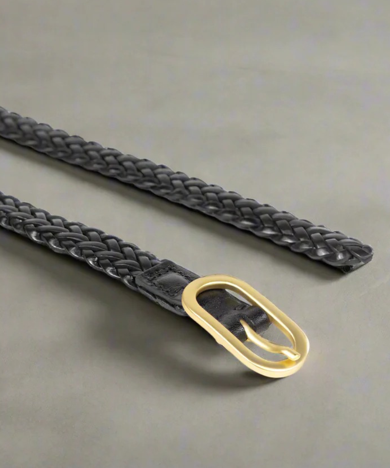 Black Royal RepubliQ womens braided belt with a gold buckle on a gray background