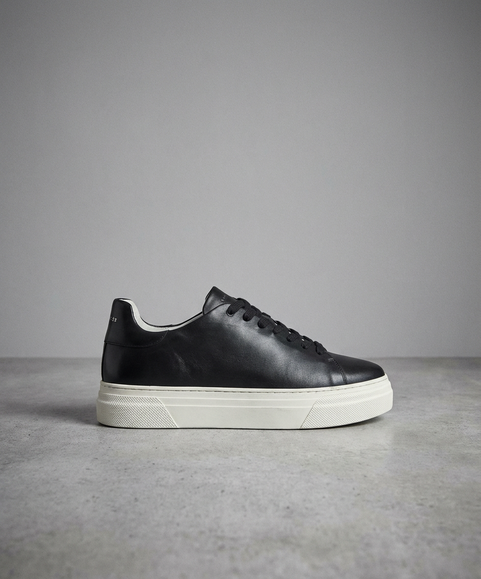 Black Royal RepubliQ leather sneaker with white sole on a gray background