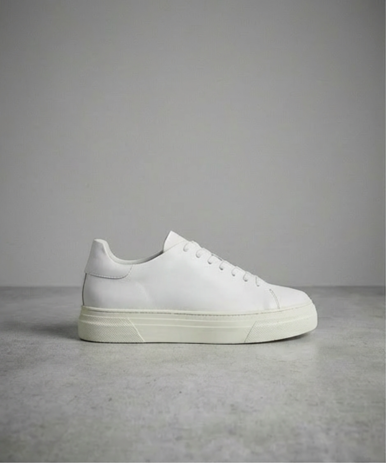 White Royal RepubliQ sneaker on a gray background