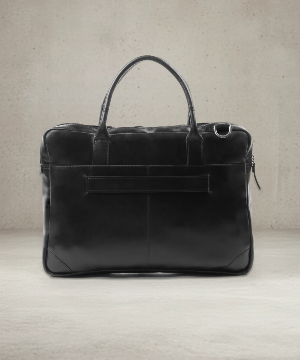 Back view of the black leather laptop bag with trolley strap