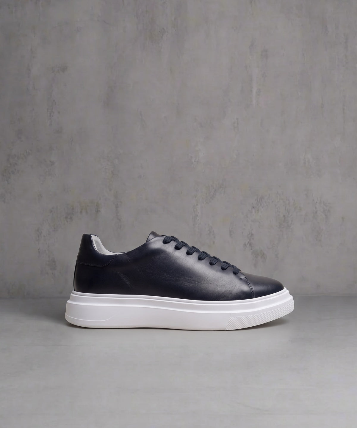 Vectra One black leather low-top sneaker with white platform sole, side profile