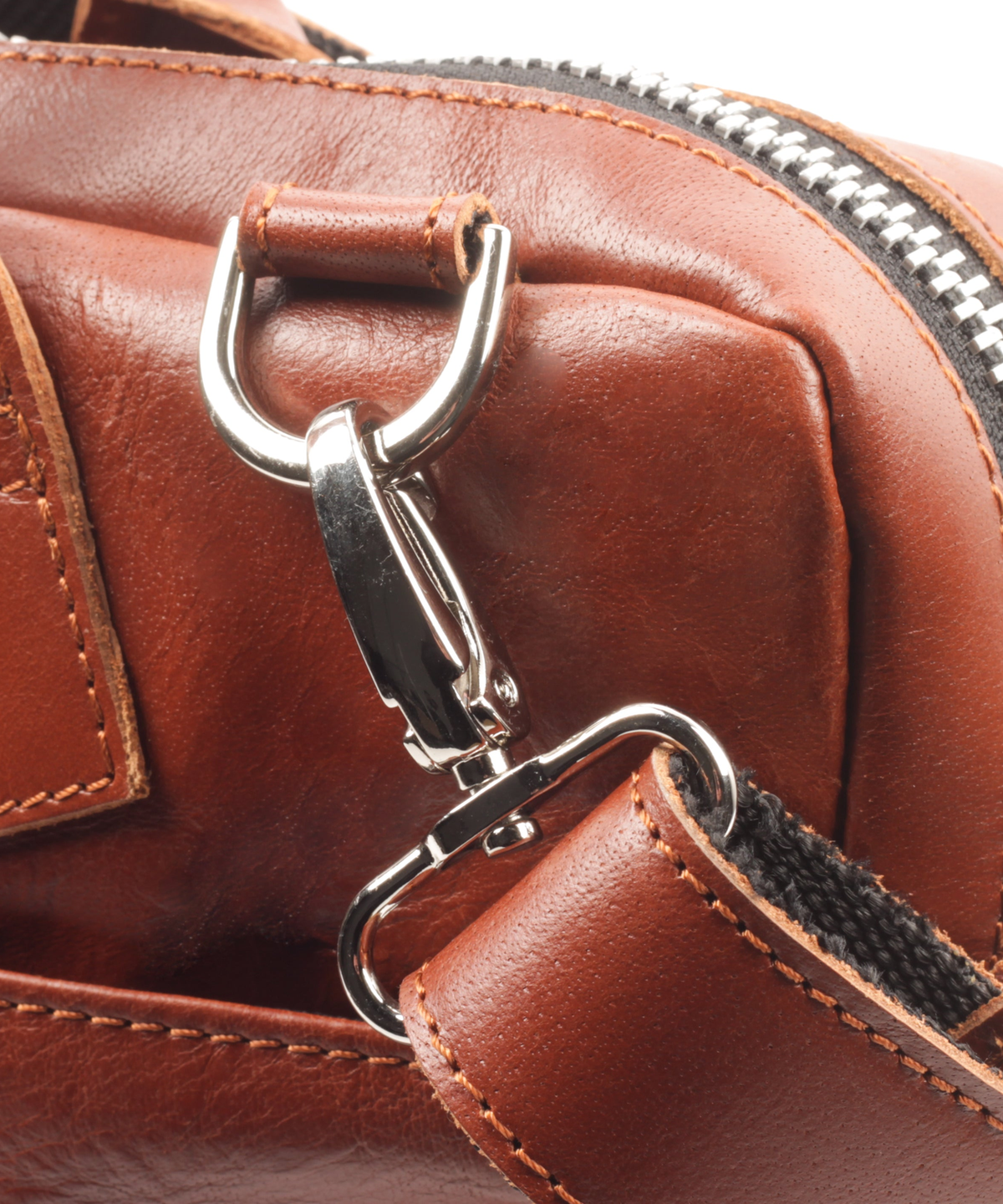 Close-up of the shoulder strap clip and D-ring on the cognac leather briefcase