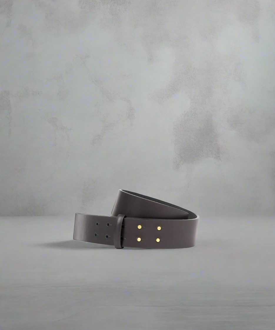 A high waist black belt with mushroom pins closure on a white background.